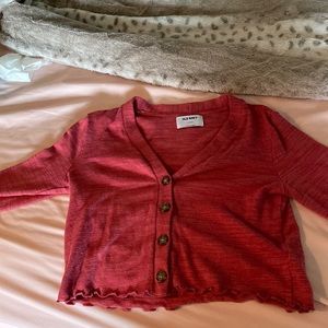 red cardigan with ruffles on sleeves and ends